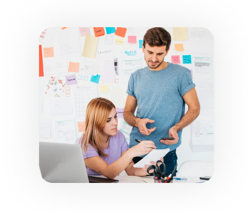 a boy and girl looking at a phone