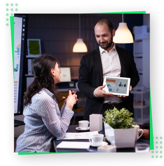 a man and woman looking at a tablet